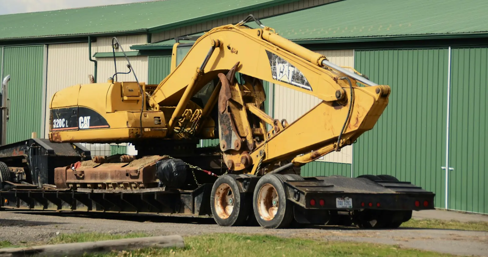 An excavator loaded on a low-loader trailer for transport